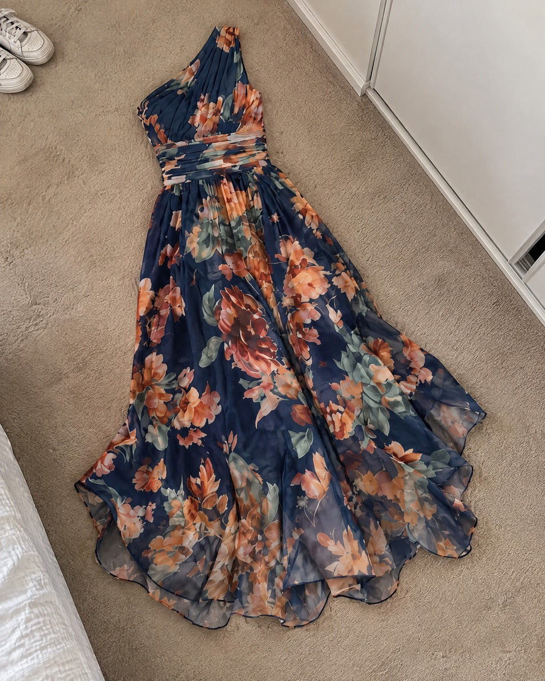 Celeste floral maxi dress laid out on bedroom carpet