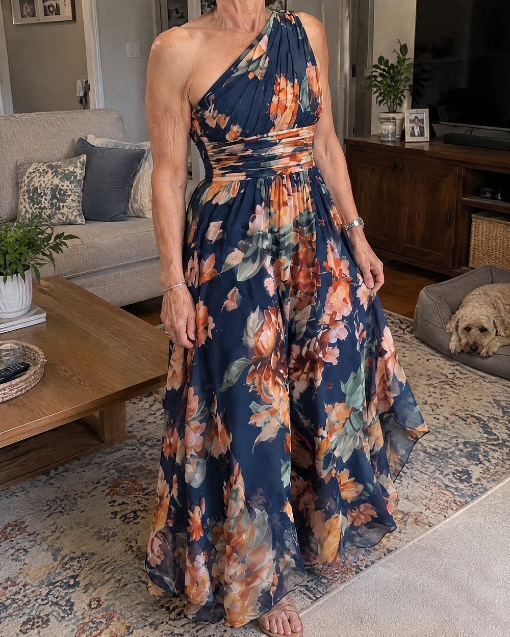 Celeste one shoulder floral maxi dress worn casually in a home living room
