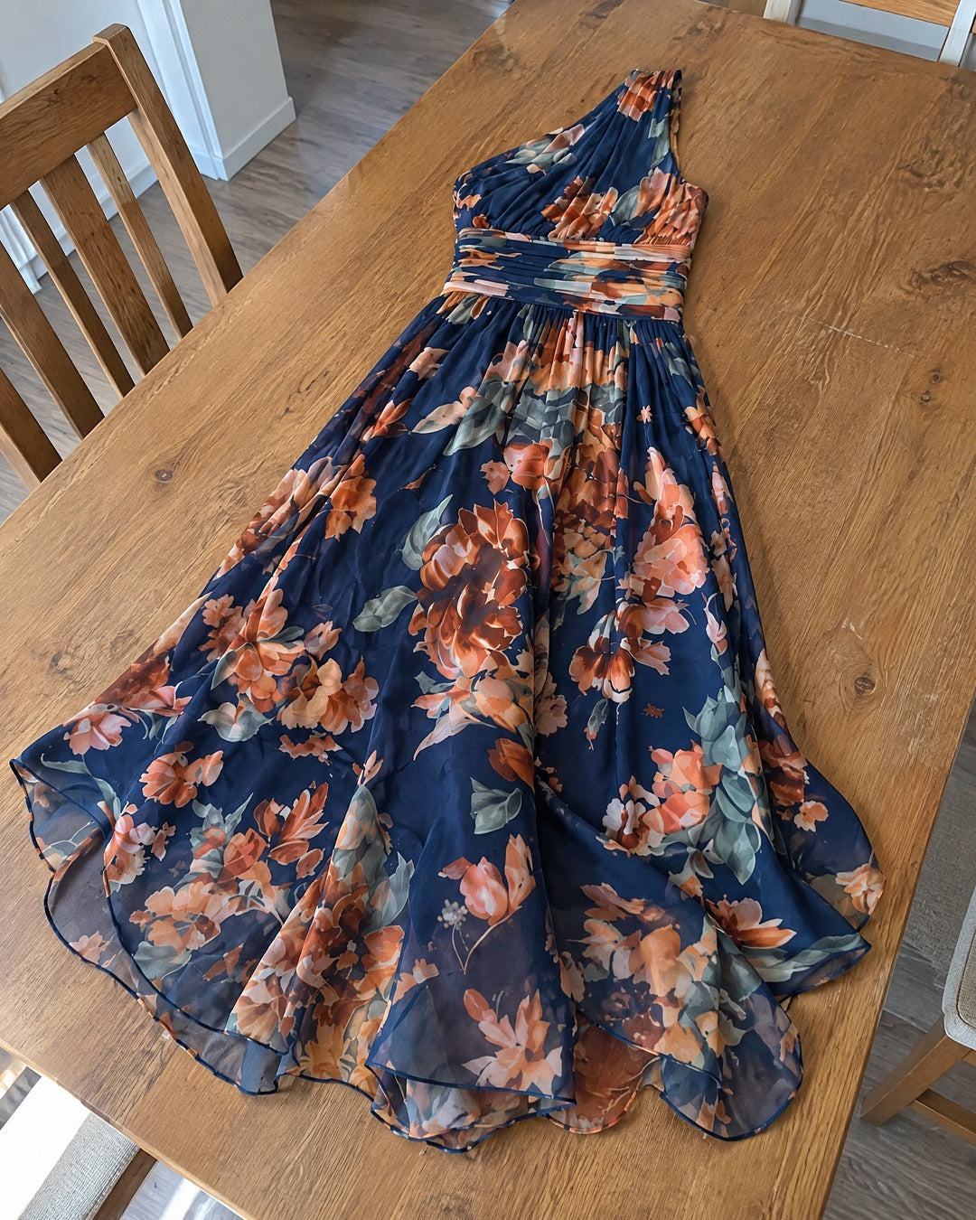 Celeste navy printed chiffon dress placed across a dining table