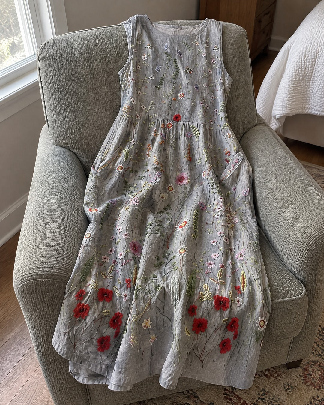 Agnes Wildflower midi dress draped across an upholstered chair in a home
