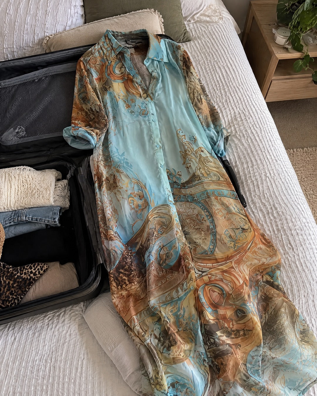 Isabella floral maxi shirt dress laid in a suitcase for a weekend away