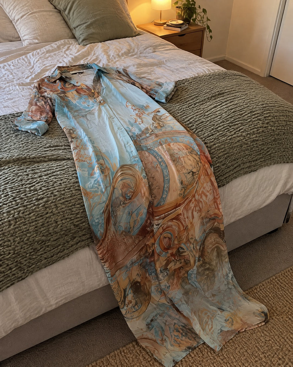 Isabella pale blue and gold patterned chiffon maxi dress across foot of bed