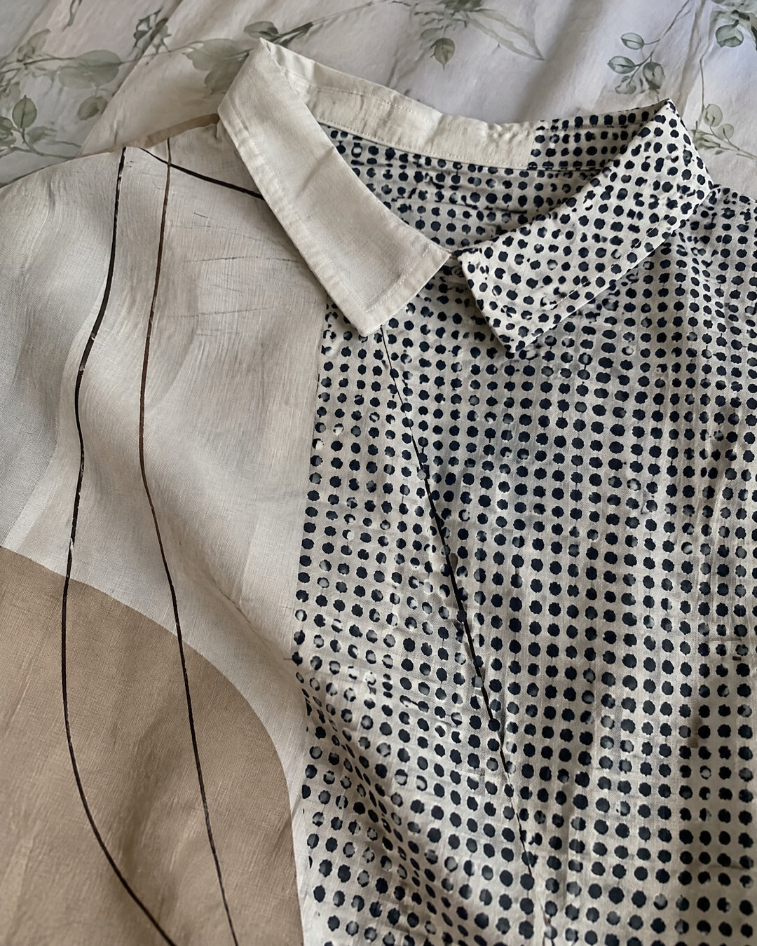 Close-up of Lana shirt collar, abstract lines and dotted fabric