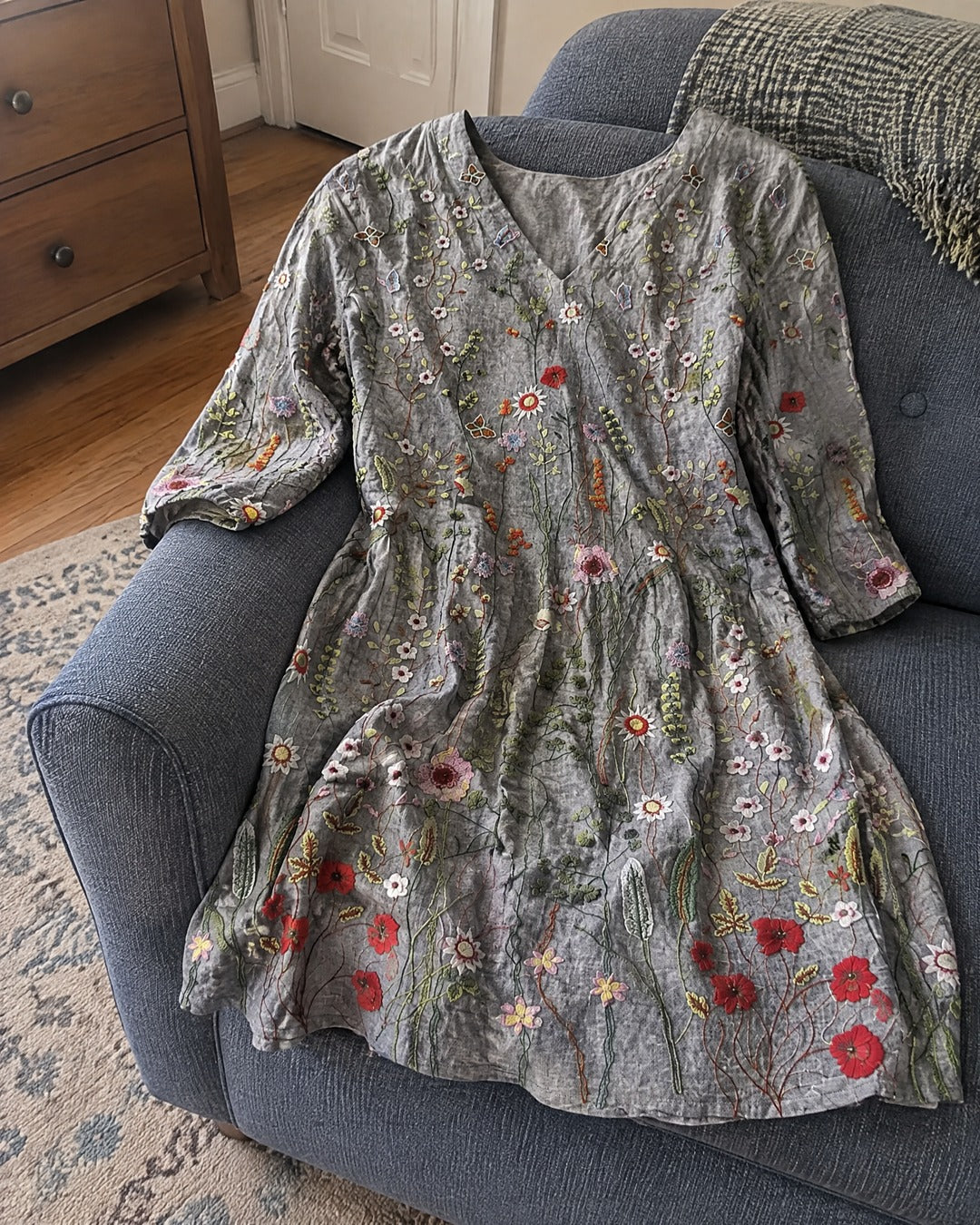 Lana grey wildflower longline blouse draped over an armchair showing relaxed silhouette