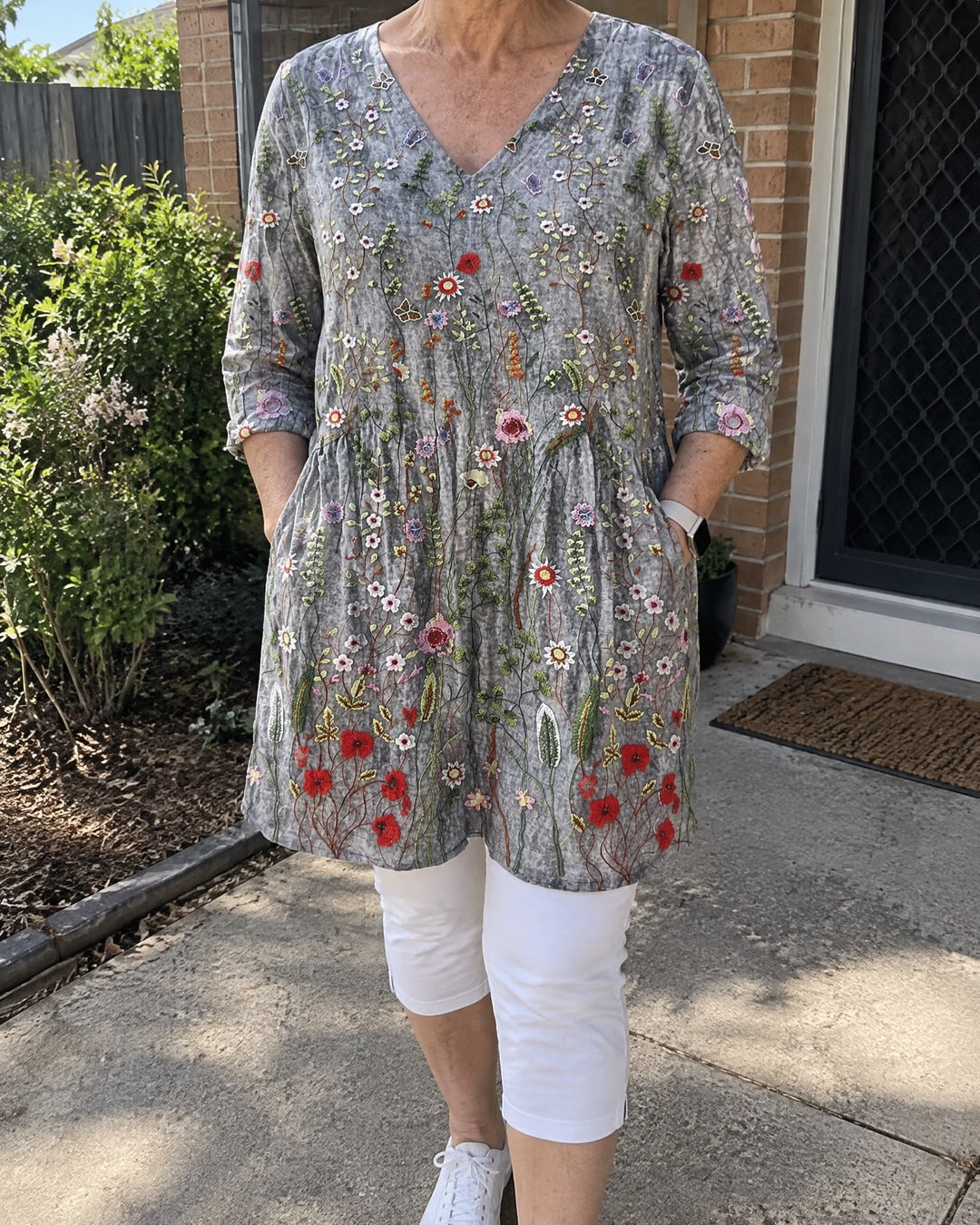 Lana floral long V-neck tunic worn outside the home with white cropped trousers