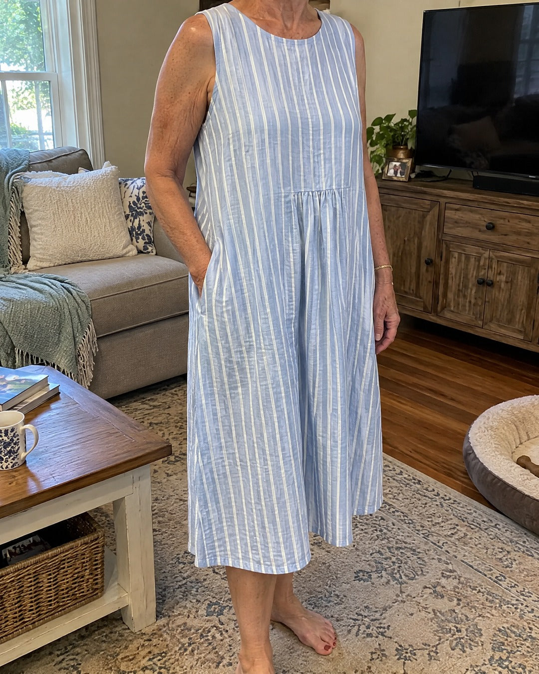 Dina blue striped midi dress worn at home showing the cut